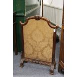 A Victorian mahogany fire screen.