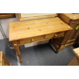 A Victorian style pine two drawer side table.