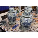 A pair of Chinese blue and white temple jars and covers.