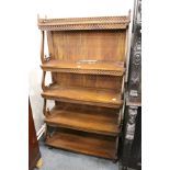 A reproduction hardwood waterfall bookcase.