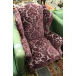A George III design wing armchair with purple cut velvet fabric on carved cabriole legs with claw