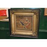 A Victorian embroidered picture in a decorative frame.