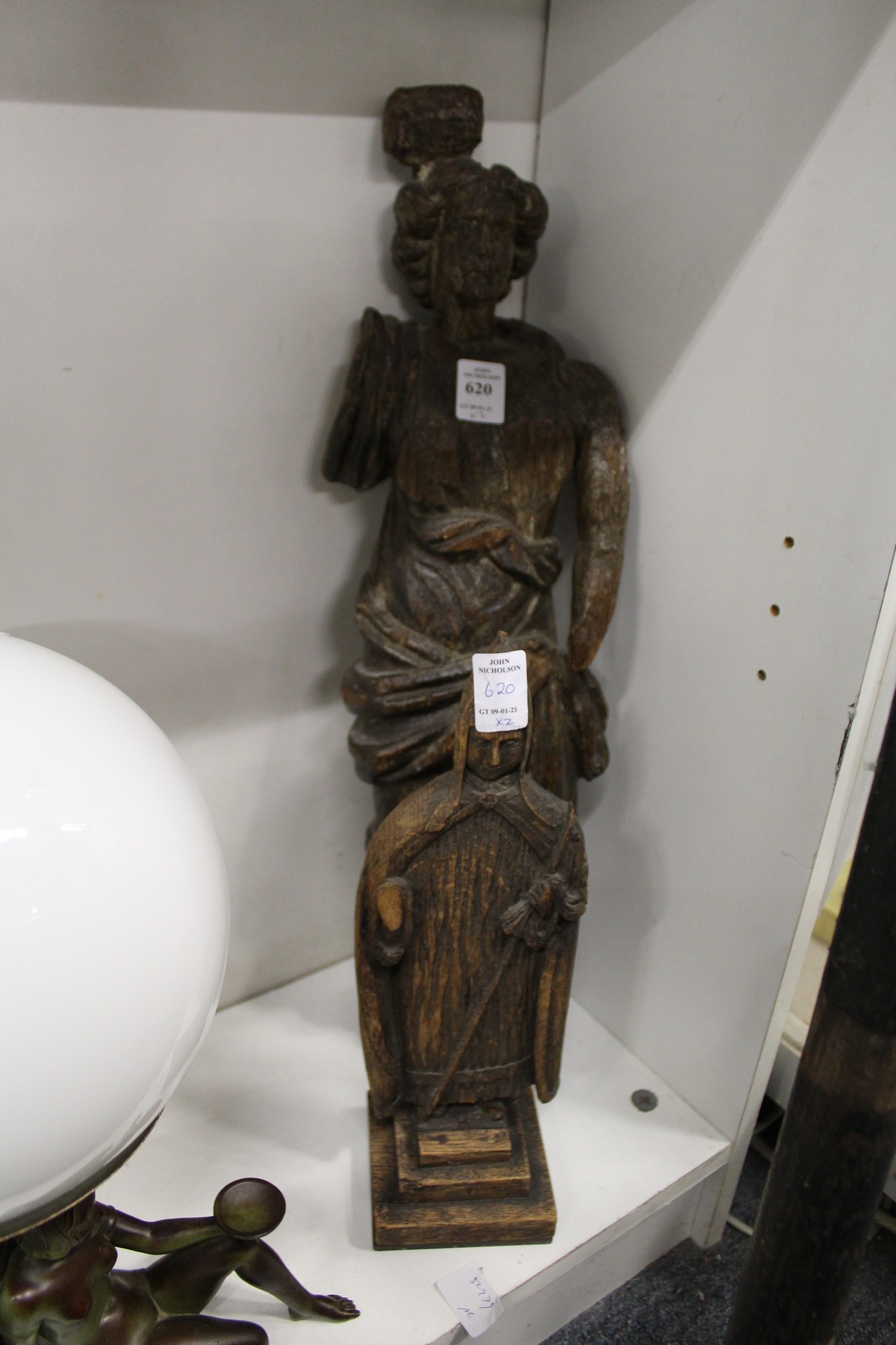 An early carved wood figure and another carved wood figure.