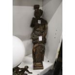 An early carved wood figure and another carved wood figure.