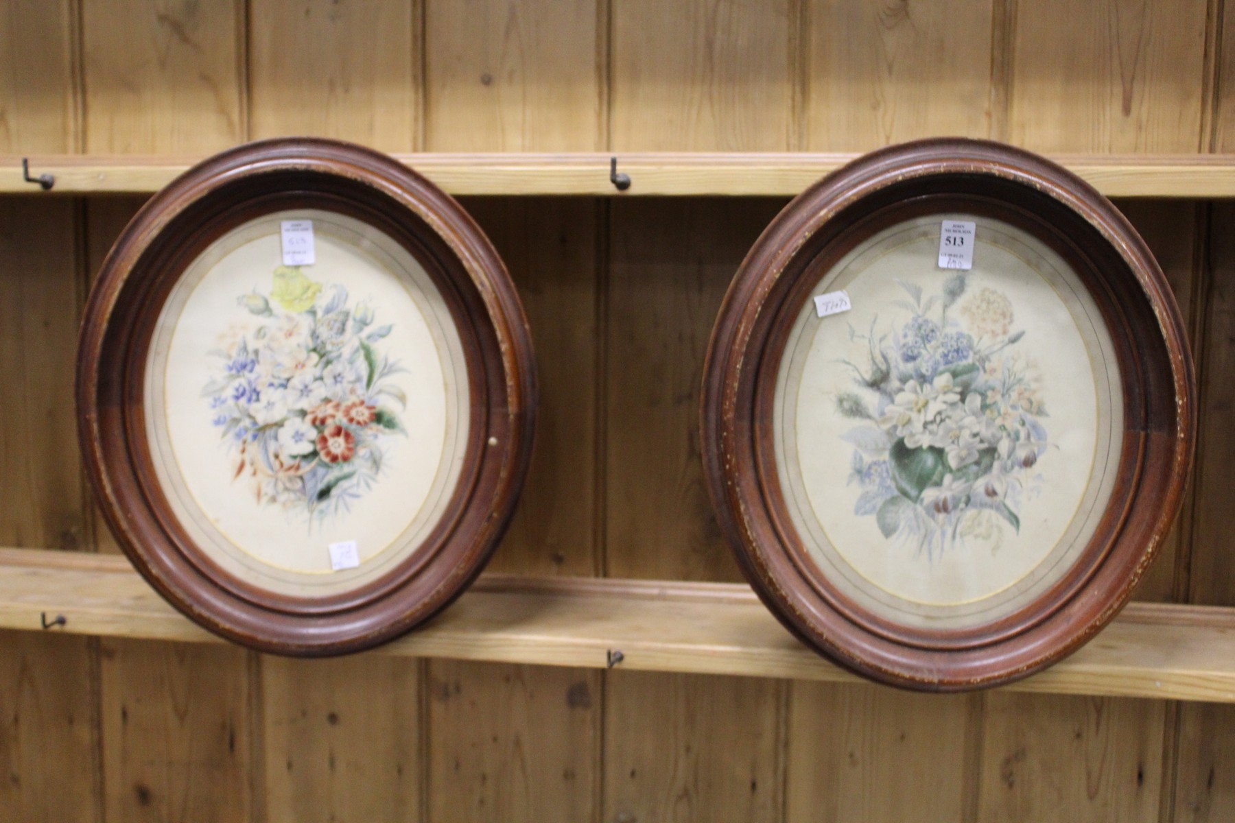A still life of flowers colour prints, a pair, framed as an oval.