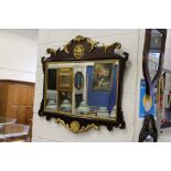 A George III style mahogany and gilt wood fretwork wall mirror.