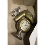 A small clock, a horse's head walking stick handle and a chrome figure.