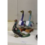 Two Chinese cloisonne geese and a similar peacock.