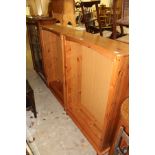 A pair of modern pine open bookcases.