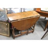 An oak drop leaf gate leg barley twist dining table.