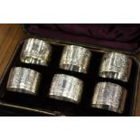 A cased set of six silver napkin rings.