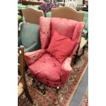 A George II style armchair upholstered in a classical crimson ground fabric on cabriole legs.