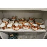 A late 19th century part tea service, possibly Spode, decorated in the classical style with orange
