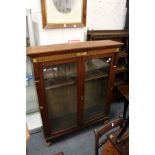 A Victorian walnut two-door glazed bookcase (alterations).