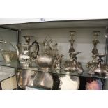 Plated wares to include a pair of ornate stands, candlesticks, an epergne etc.