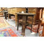 A pair of orientalist oak lamp tables with metal mounts.