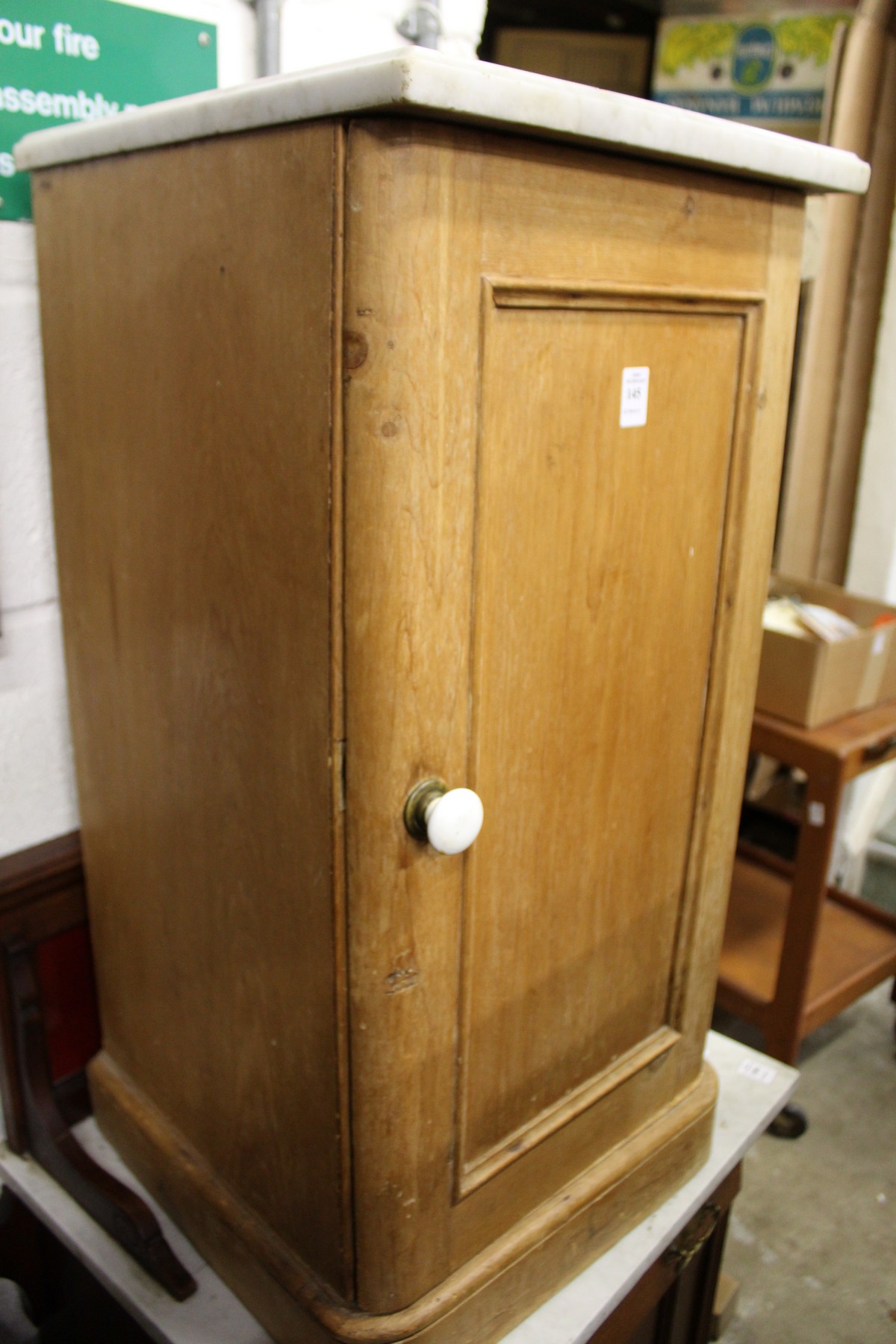 A Victorian pine pot cupboard with later marble top.