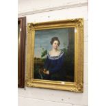 A portrait of a young lady wearing a blue dress, oil on canvas, in a decorative gilt frame.