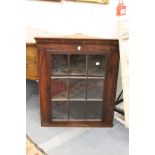 A mahogany hanging corner cabinet.