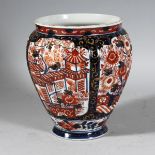 A JAPANESE IMARI PLANTER with four panels of flowers. 8ins high.
