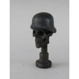 A SMALL BRONZE SKULL PIPE TAMPER. 1.5ins.