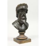A SMALL BRONZE BUST on a square base. 7ins high.