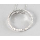AN 18CT WHITE GOLD AND DIAMOND (0.39cts) CIRCLE PENDANT on a chain.