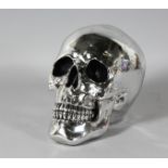 A SILVERED SKULL. 8ins high.
