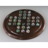 A LARGE SOLITAIRE BOARD, 11ins diameter, and marbles.