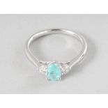 AN 18CT WHITE GOLD THREE STONE PARAIBA TOURMALINE (0.47cts) AND DIAMOND (0.18cts) RING.