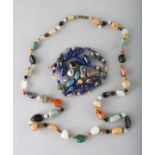 AN ITALIAN COLOURED GLASS BAG OF BEADS and A HARDSTONE NECKLACE.