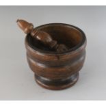 A LATE 18TH CENTURY TURNED FRUITWOOD PESTLE AND MORTAR.