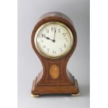 A SMALL EDWARDIAN MAHOGANY INLAID BALLOON SHAPED CLOCK on four brass ball feet. 8.5ins high.