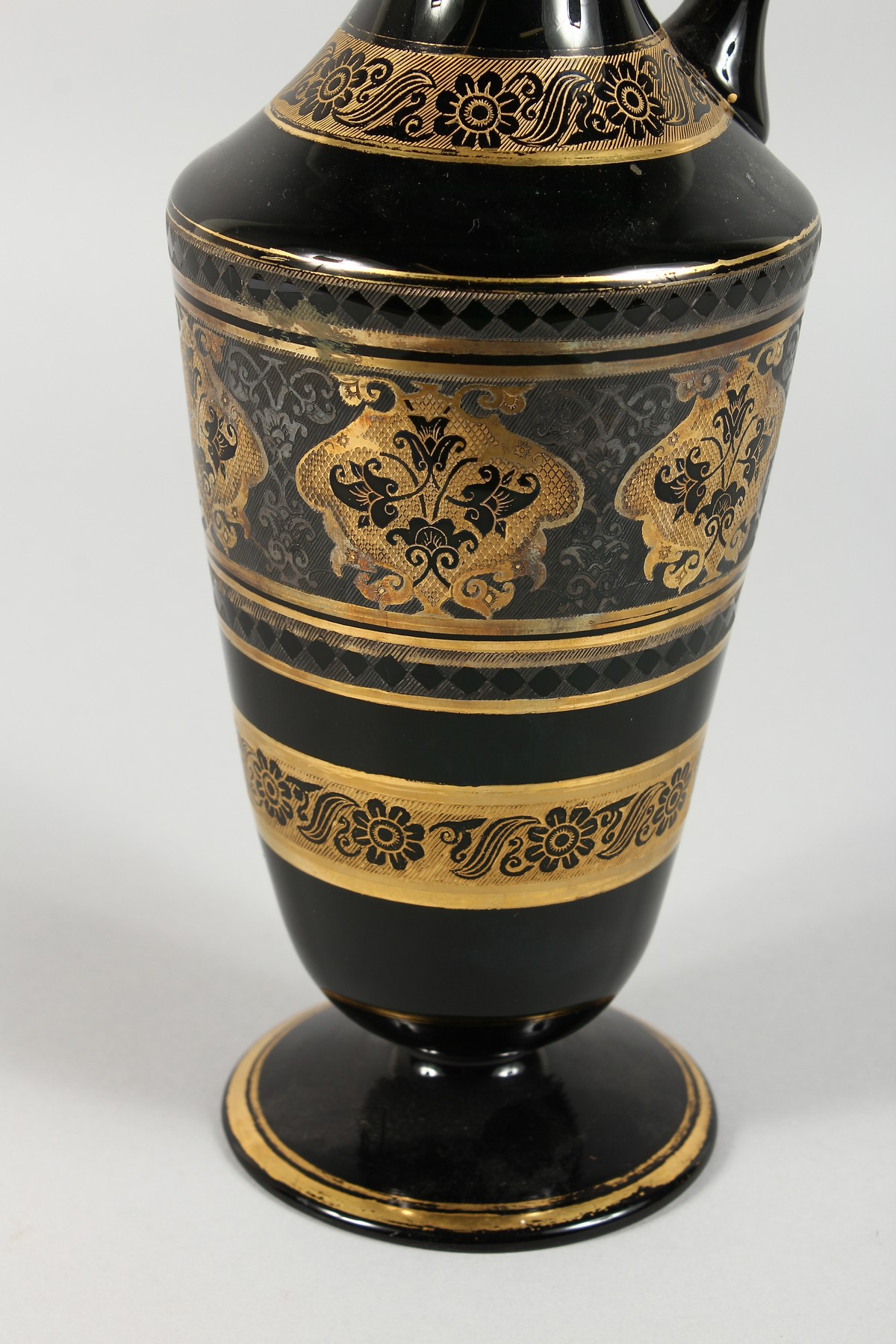 A CONTINENTAL DARK GREEN GLASS EWER AND STOPPER, with etched and gilded decoration. 14ins high. - Image 2 of 11