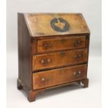 A GEORGE III MAHOGANY AND INLAID BUREAU, with a fall flap over three drawers, on bracket feet. 2ft