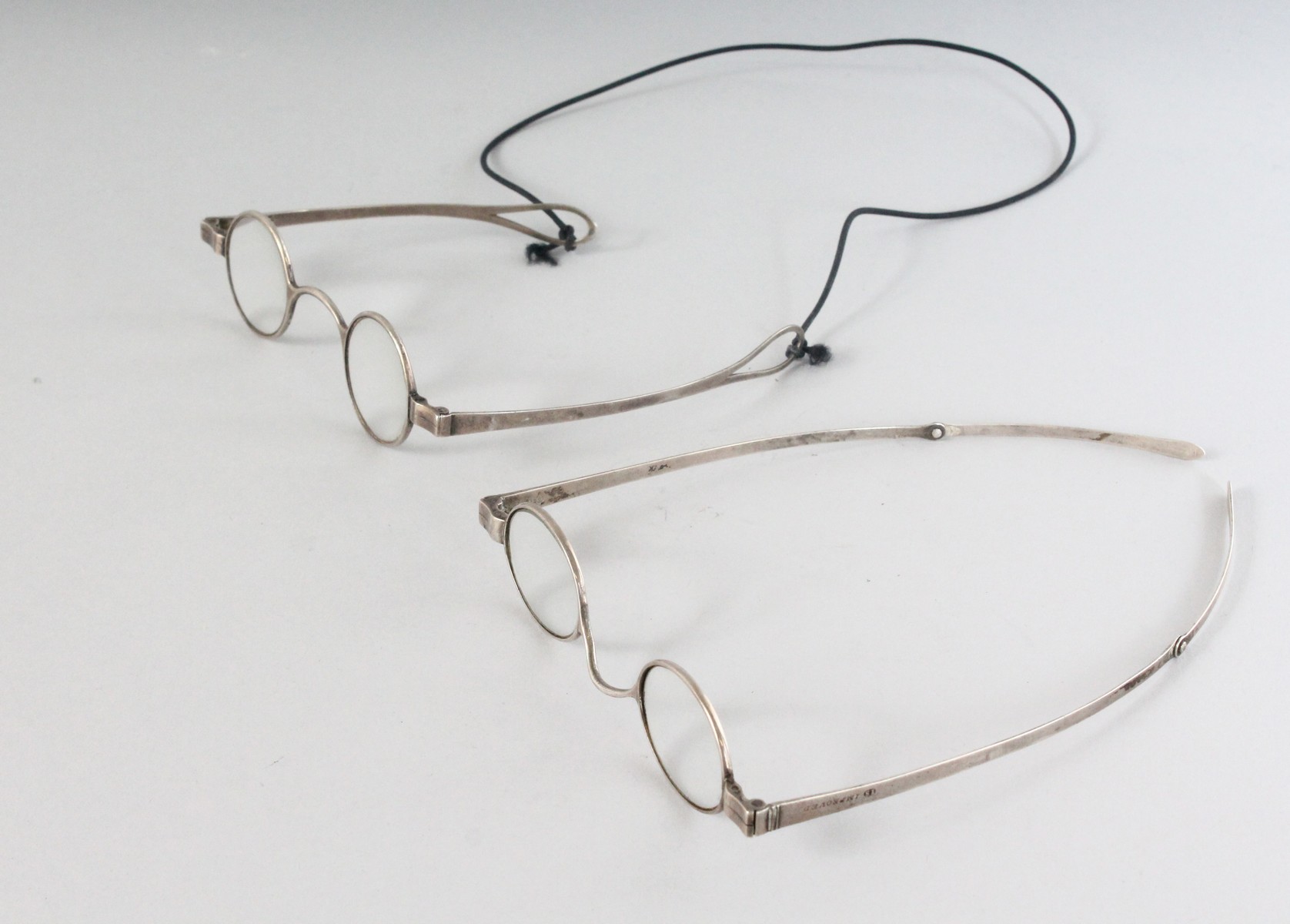 A RARE PAIR OF VICTORIAN SILVER SPECTACLES and A GEORGIAN PAIR (2).