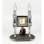 AN ART DECO CHROME PLATED ELECTRIC MANTLE CLOCK, by Genalex, with a square dial suspended between