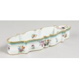 A RARE MEISSEN LONG INKWELL painted with flowers. Cross swords mark in blue. 10.75ins long.