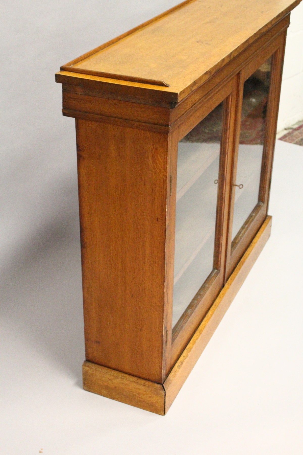 A VICTORIAN LIGHT OAK TWO-DOOR BOOKCASE, with a pair of glazed doors enclosing adjustable shelves, - Image 4 of 5