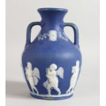 A BLUE JASPER WARE TWO HANDLED PORTLAND VASE. 7.5ins high.