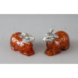 A PAIR OF AMBER RABBITS with silver heads.