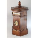 A GOOD MAHOGANY OCTAGONAL POST BOX in the Victorian style, with letter box and front door.