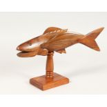 A PITCAIRN ISLAND CARVED WOOD FLYING FISH ON STAND, unsigned. 13ins long.