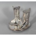 A SILVER PLATE HUNTING THREE PIECE CONDIMENT, pair of boots and a cap.