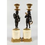 A SUPERB PAIR OF REGENCY BRONZE, ORMOLU AND MARBLE CUPIDS, formed as standing bronze cupids