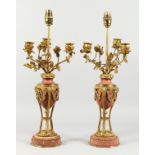 A VERY GOOD PAIR OF REGENCY, ORMOLU AND MARBLE URN SHAPED THREE BRANCH CANDELABRA, mounted with rams