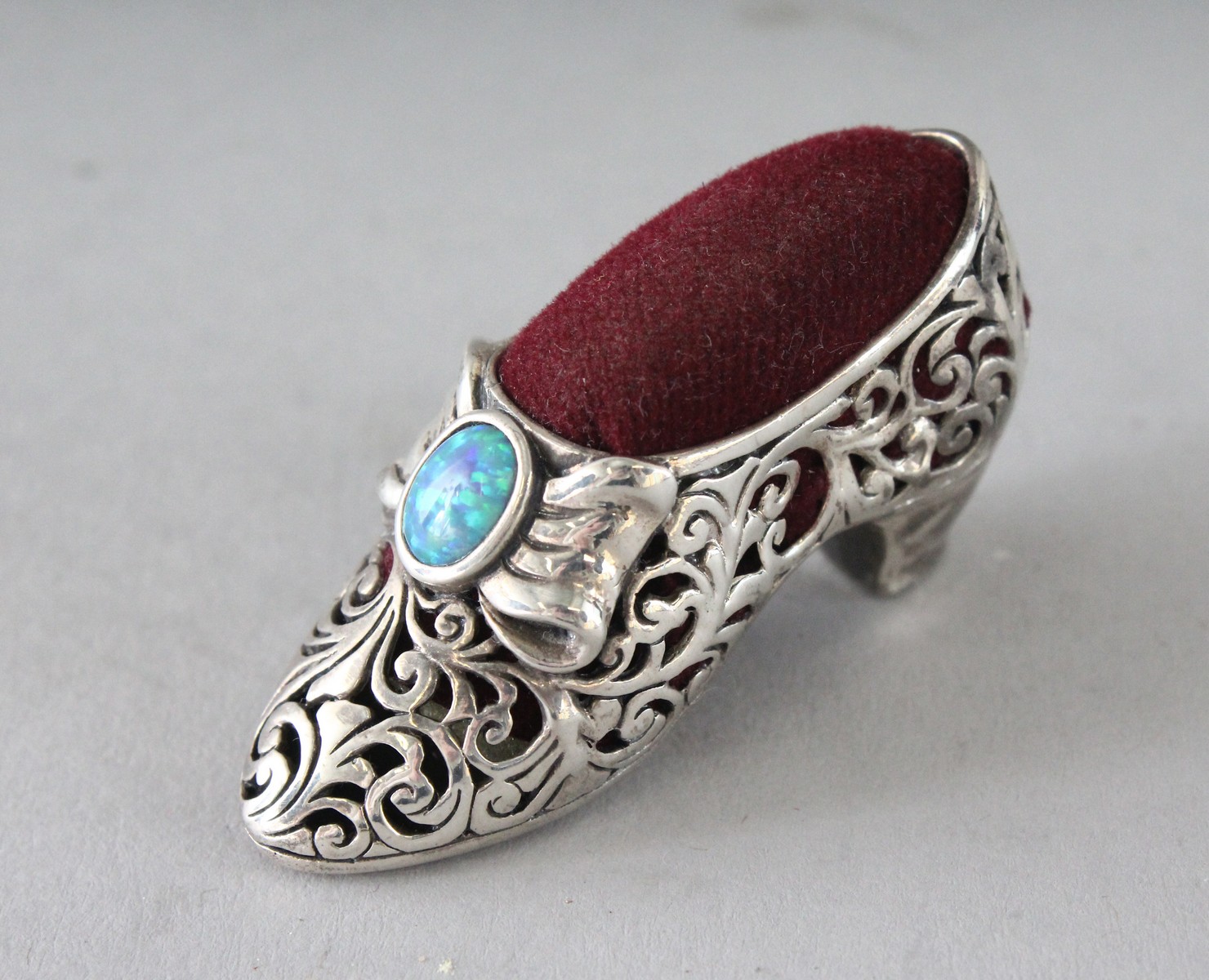 A SILVER OPAL SHOE PIN CUSHION. 2ins