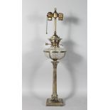 A SILVER PLATED CORINTHIAN COLUMN OIL LAMP with cut glass reservoir. 30ins high.