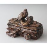 A GOOD SMALL BLACK FOREST CARVED WOOD JEWELLERY BOX formed as a dog with a bird and oak leaves. 6.