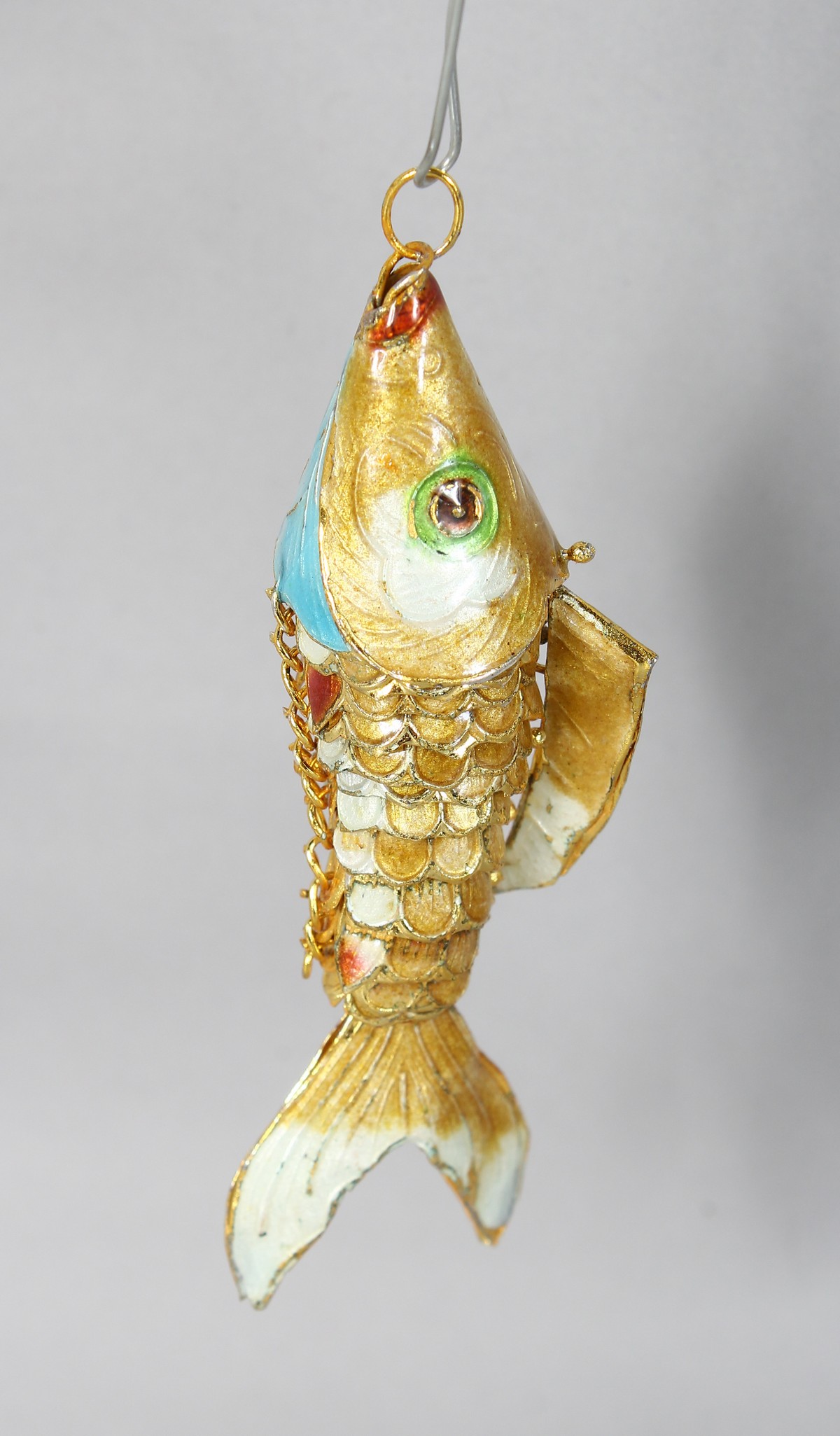 AN ENAMEL FISH PENDANT. 3.5ins long.